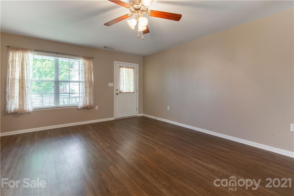 3002 Arthur Road Indian Land, SC 29707 - Photo 6 of 25 a view of an empty room with wooden floor and a window