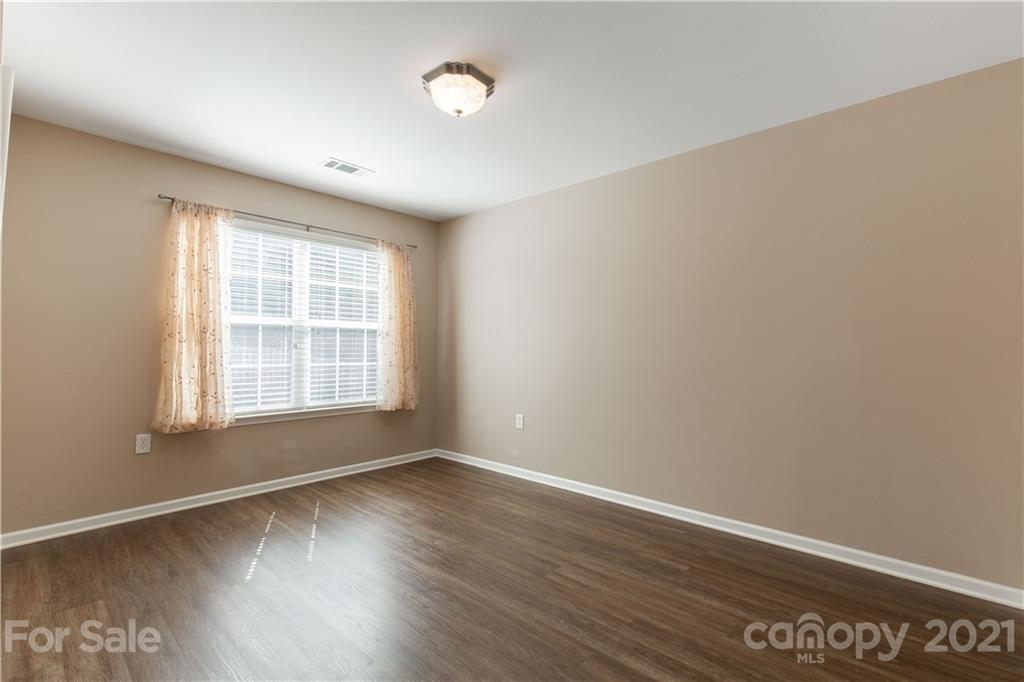3002 Arthur Road Indian Land, SC 29707 - Photo 7 of 25 an empty room with wooden floor and windows