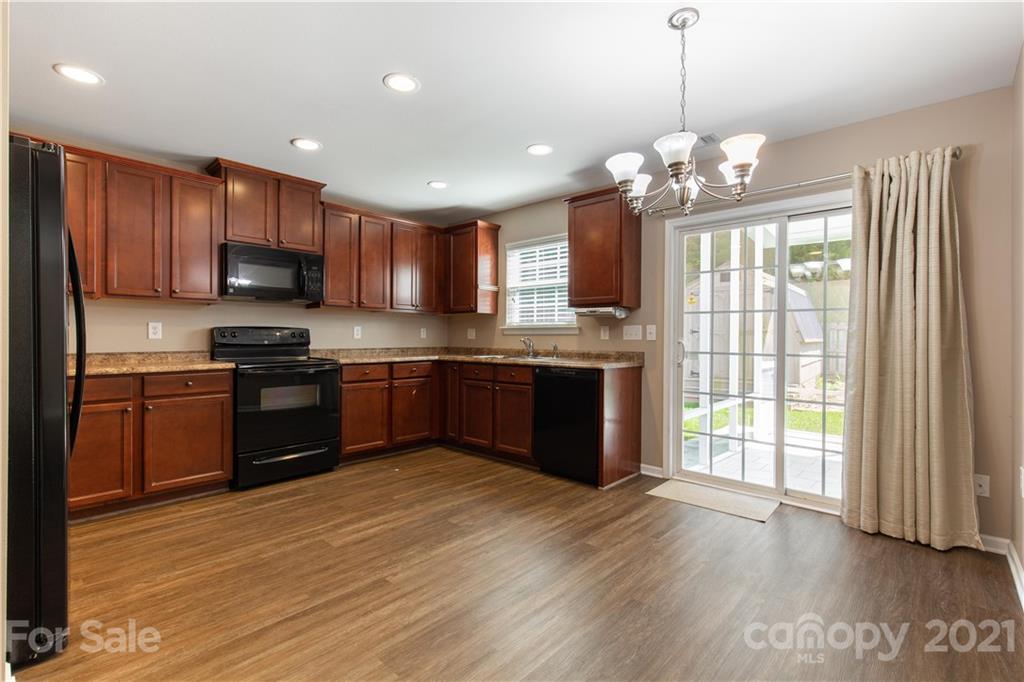 3002 Arthur Road Indian Land, SC 29707 - Photo 10 of 25 a kitchen with stainless steel appliances granite countertop a stove top oven a sink dishwasher a refrigerator and a microwave