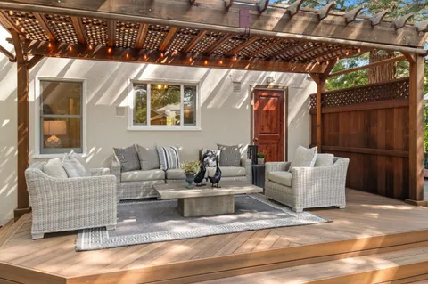 a living room with furniture and a black gate