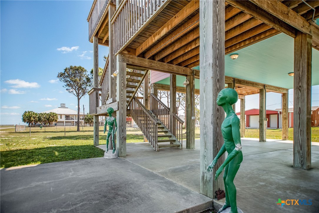 211 Taylor Avenue Port O'Connor, TX 77982 - Photo 12 of 43 a porch with a table and chairs and potted plants