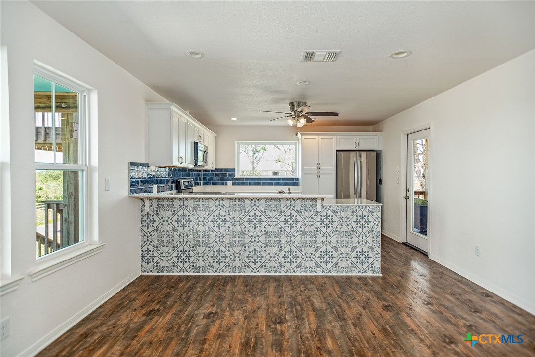 211 Taylor Avenue Port O'Connor, TX 77982 - Photo 27 of 43 a living room with kitchen island granite countertop furniture and wooden floor