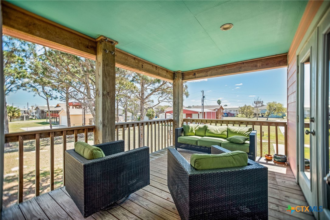 211 Taylor Avenue Port O'Connor, TX 77982 - Photo 31 of 43 a balcony with furniture and a floor to ceiling window