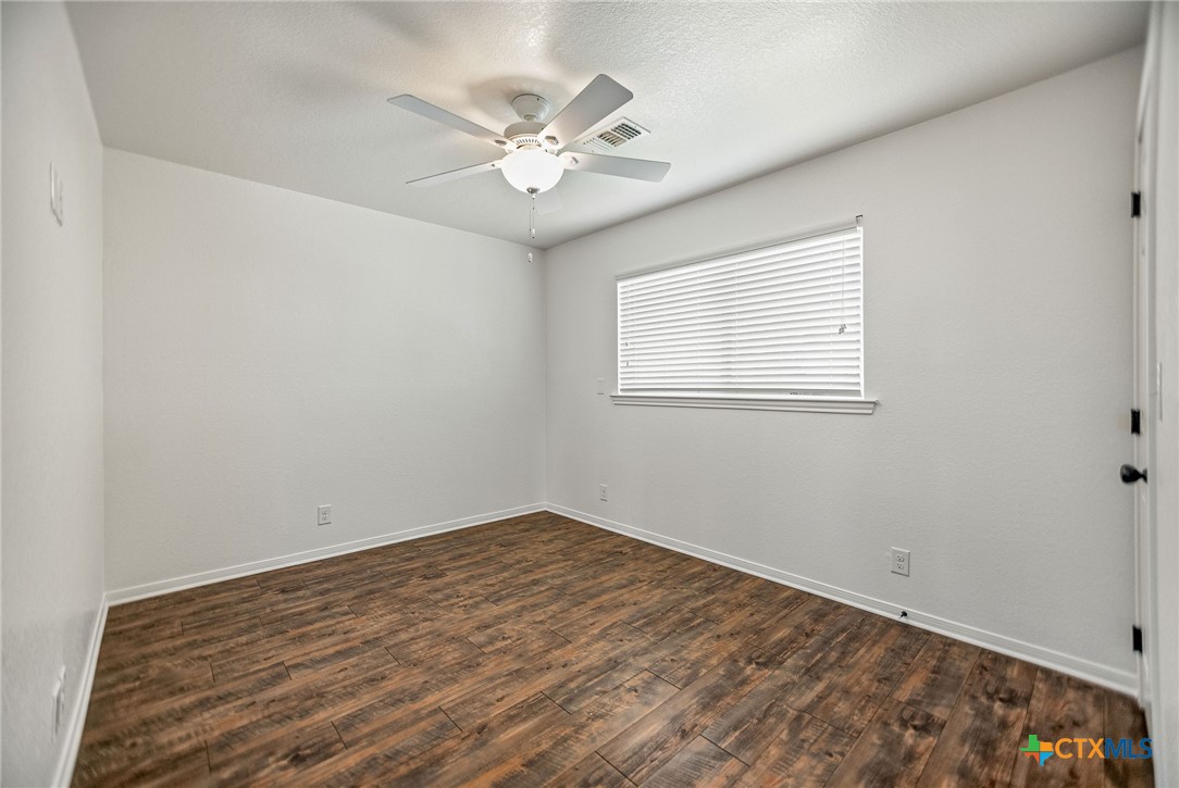 211 Taylor Avenue Port O'Connor, TX 77982 - Photo 38 of 43 wooden floor in an empty room with a window