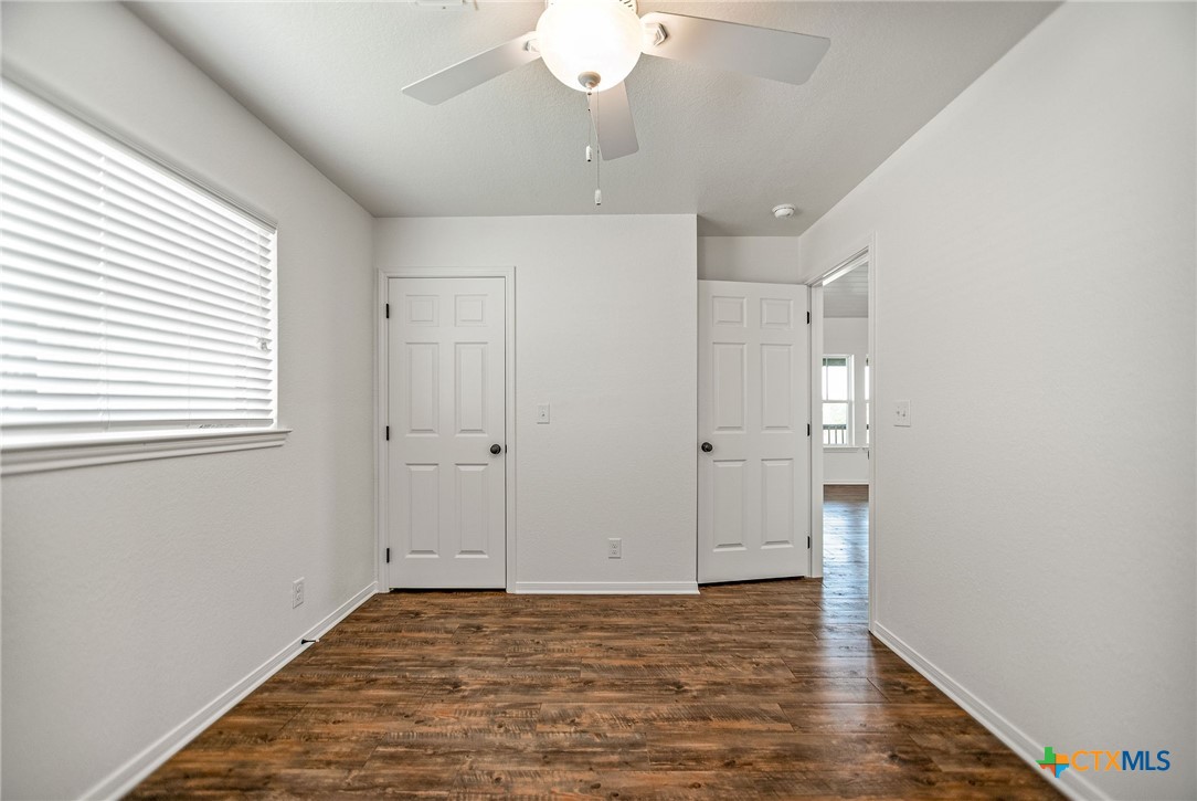 211 Taylor Avenue Port O'Connor, TX 77982 - Photo 39 of 43 a view of an empty room with wooden floor and a window