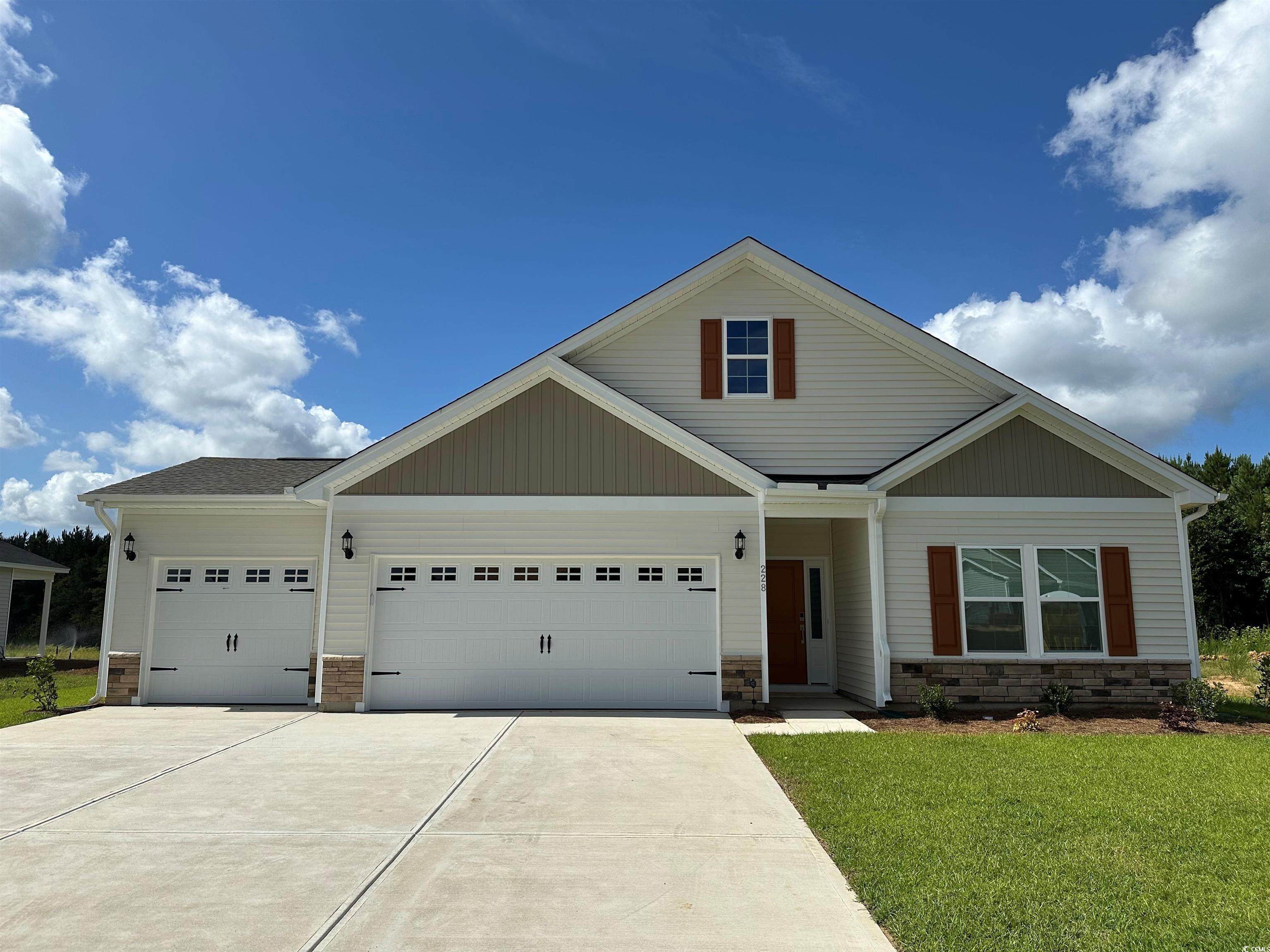 228 Sundrop Way Conway, SC 29526 - Photo 1 of 1 Craftsman-style house featuring stone siding, a ga