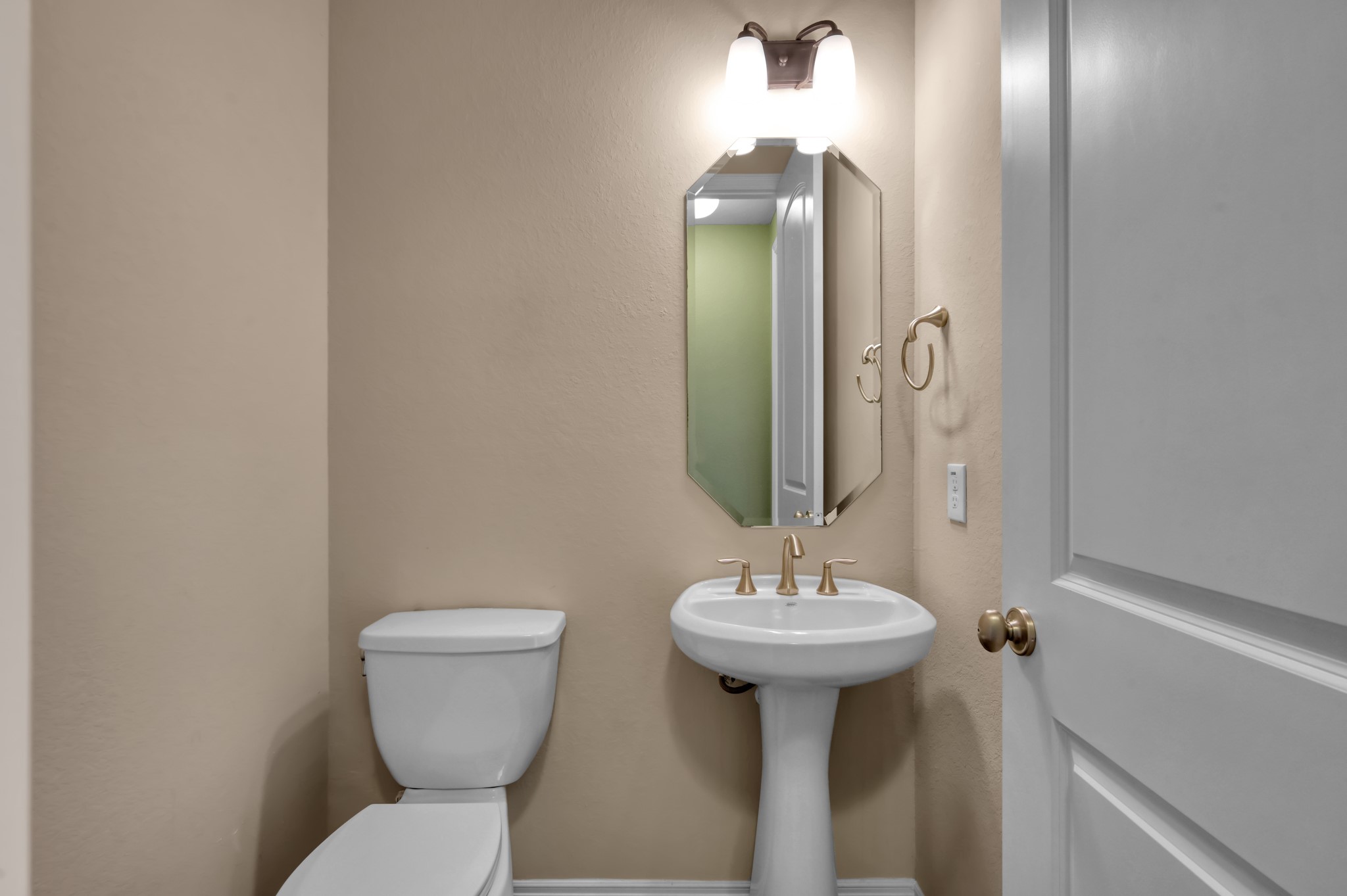 23219 Belted Kingfisher Trail Spring, TX 77389 - Photo 28 of 43 a bathroom with a toilet sink and mirror