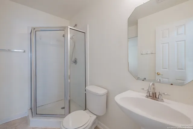 a bathroom with a toilet sink and shower