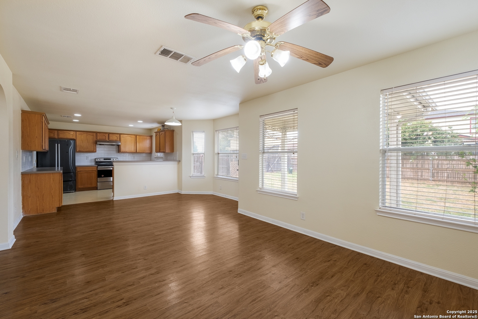 4946 Orchid Star San Antonio, TX 78218 - Photo 4 of 11 a view of an empty room with wooden floor and a window