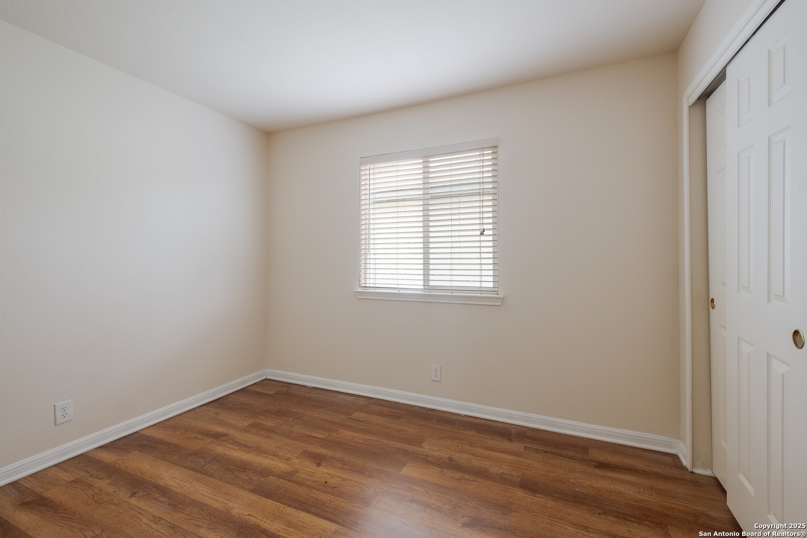 4946 Orchid Star San Antonio, TX 78218 - Photo 10 of 11 wooden floor in an empty room with a window