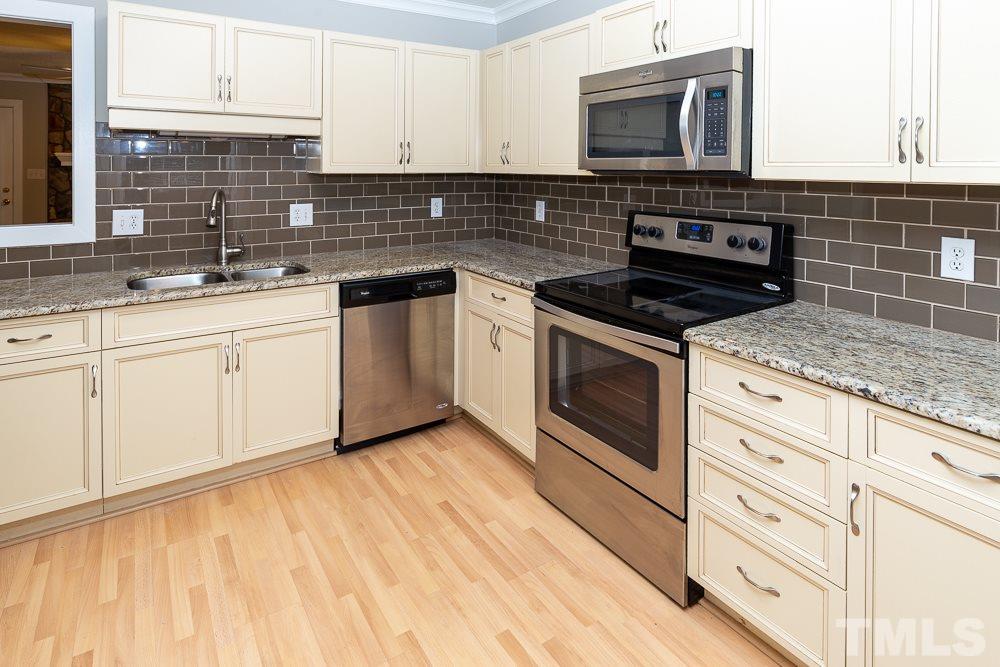 1403 Quarter Point Raleigh, NC 27615 - Photo 3 of 19 a kitchen with granite countertop cabinets stainless steel appliances and a sink
