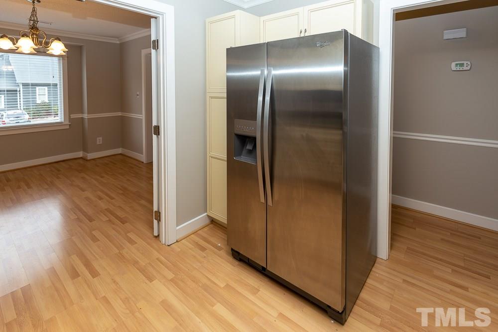 1403 Quarter Point Raleigh, NC 27615 - Photo 4 of 19 an empty room with wooden floor mirror and windows