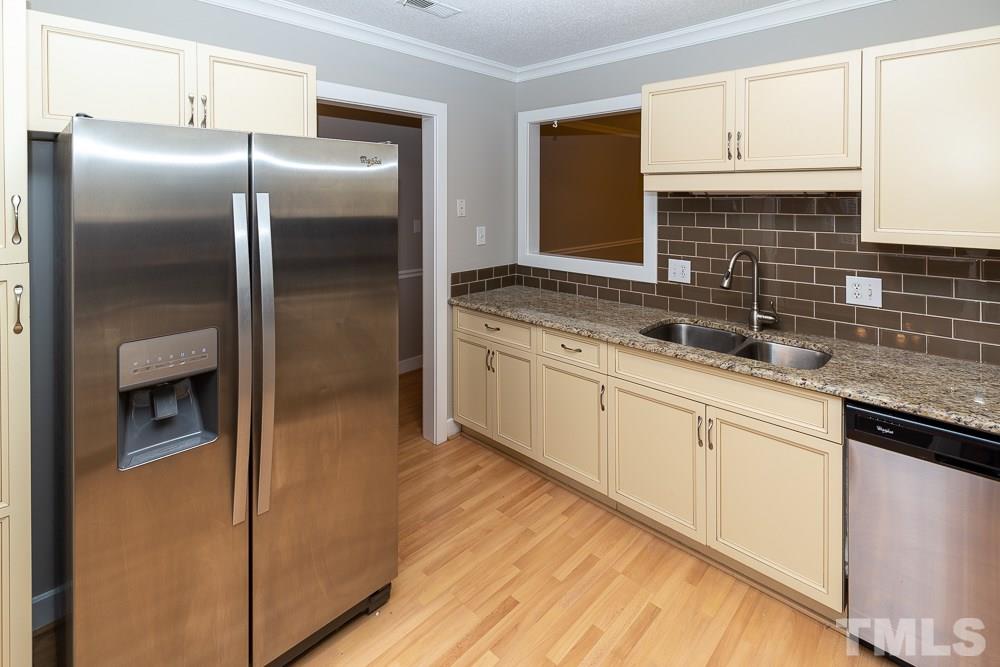1403 Quarter Point Raleigh, NC 27615 - Photo 5 of 19 a kitchen with stainless steel appliances granite countertop a refrigerator and a sink