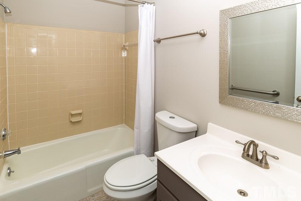1403 Quarter Point Raleigh, NC 27615 - Photo 9 of 19 a bathroom with a sink a toilet and shower