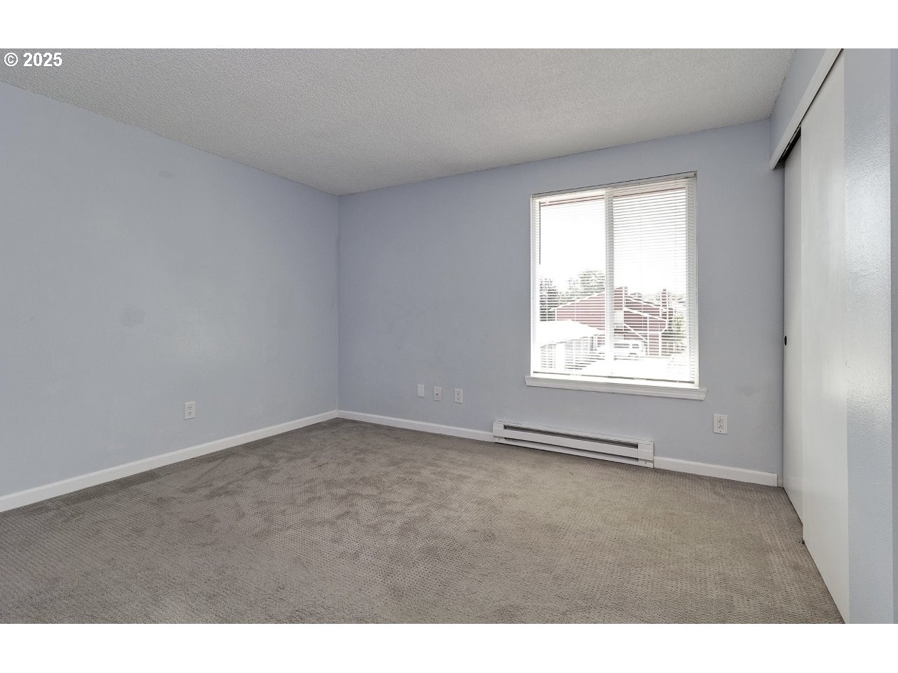 1470 Southeast Walnut Street, Unit 210 Hillsboro, OR 97123 - Photo 12 of 16 a view of an empty room with a window