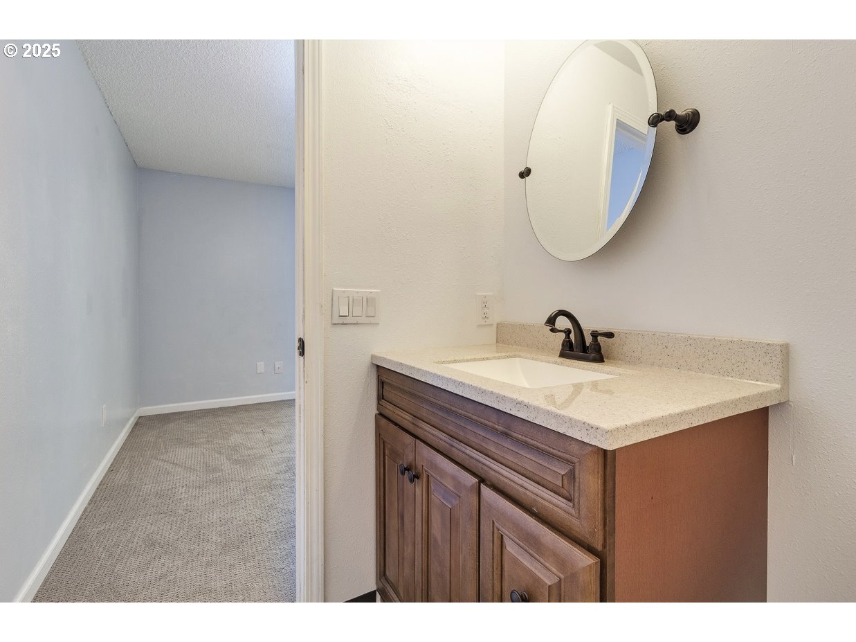 1470 Southeast Walnut Street, Unit 210 Hillsboro, OR 97123 - Photo 16 of 16 a bathroom with a sink vanity and a mirror