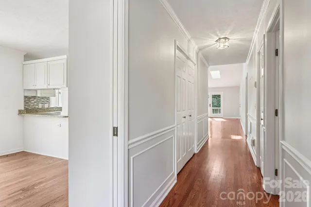 a view of a hallway with wooden floor