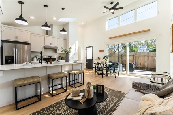 a living room with fireplace furniture and a large window