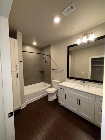 a bathroom with a large mirror and a bathtub