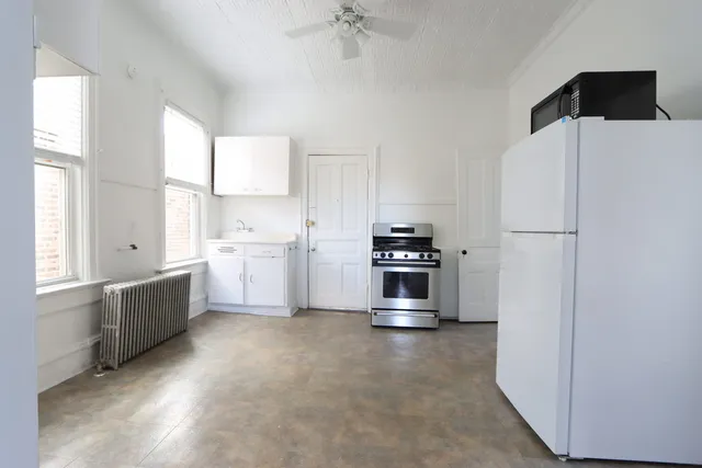 a kitchen with stainless steel appliances a refrigerator sink and cabinets