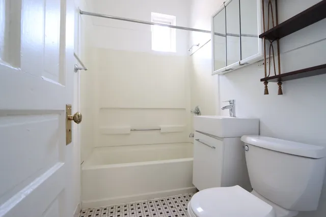 a bathroom with a toilet a sink and bathtub