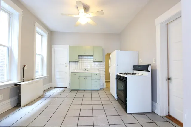 a kitchen with a stove a sink and a refrigerator