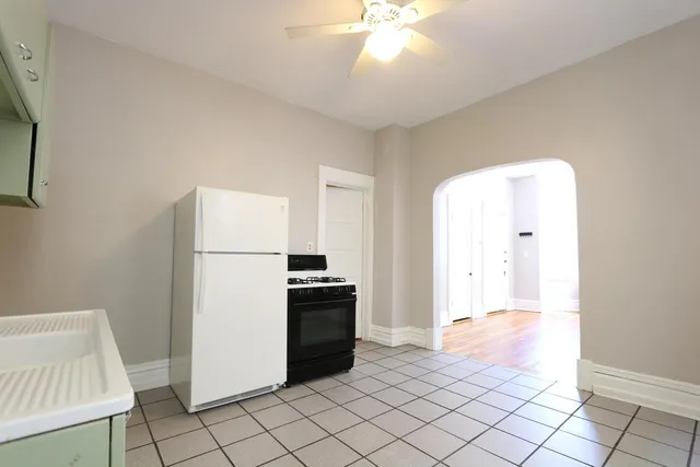 a view of kitchen with furniture refrigerator and window