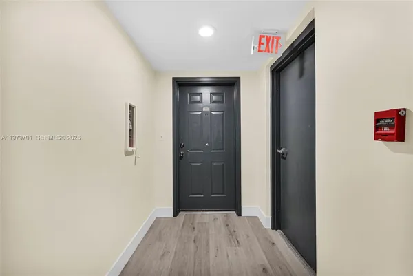 a view of hallway with wooden floor