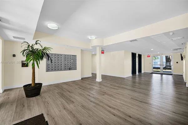 a view of a room with a potted plant and wooden floor