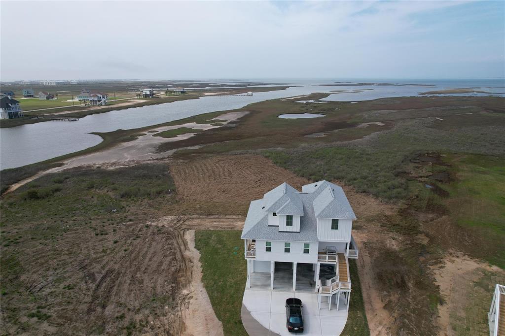 an aerial view of a house with ocean view