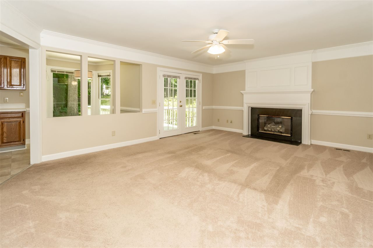 8113 Coleraine Court Raleigh, NC 27615 - Photo 12 of 28 Family Room with Gas Log fireplace and door leading onto back deck. Family Room