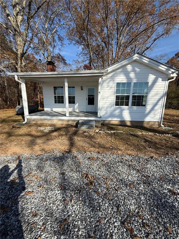 343 Chastain Mill Road Dawsonville, GA 30534 - Photo 1 of 12 a front view of house with yard space and seating area