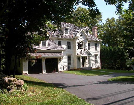 77 Turkey Hill Road South Westport, CT 06880 - Photo 1 of 1 a front view of a house with a garden and trees