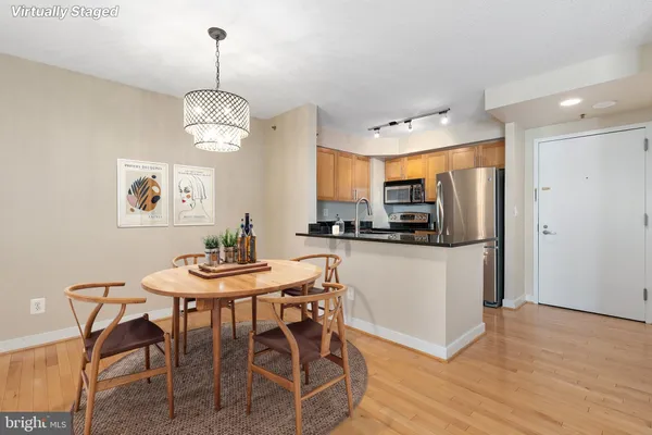 a view of a dining room with furniture wooden floor and chandelier