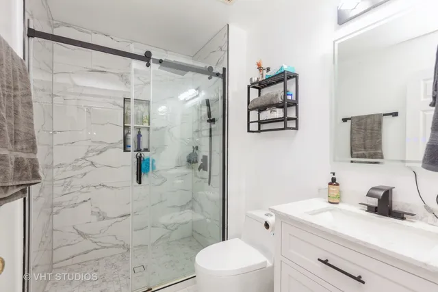 a bathroom with a sink vanity granite and a toilet