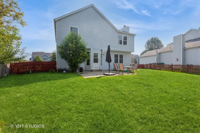 a front view of house with a garden