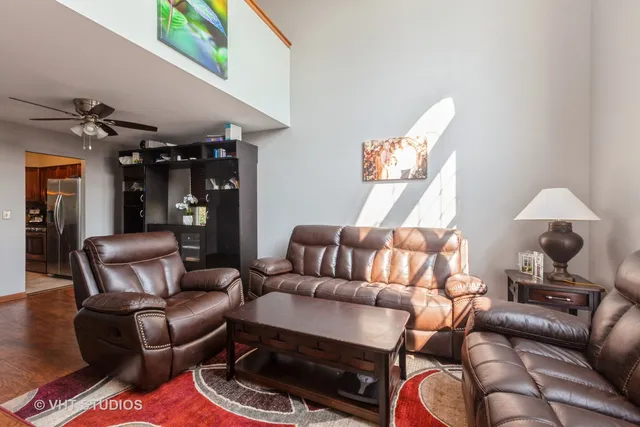 a living room with furniture and a lamp