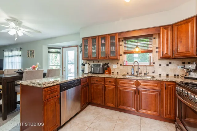 a kitchen with a sink stove top oven and cabinets
