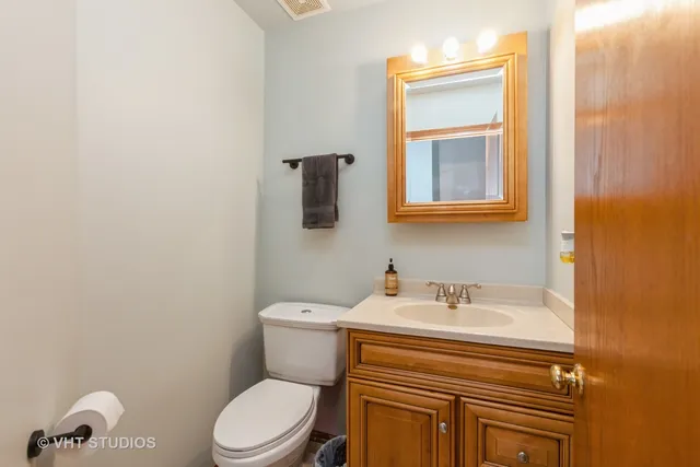 a bathroom with a sink a toilet and mirror