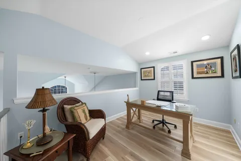 a workspace with furniture and a wooden floor