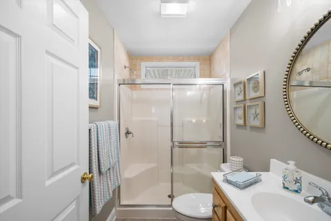 a bathroom with a sink mirror vanity and toilet