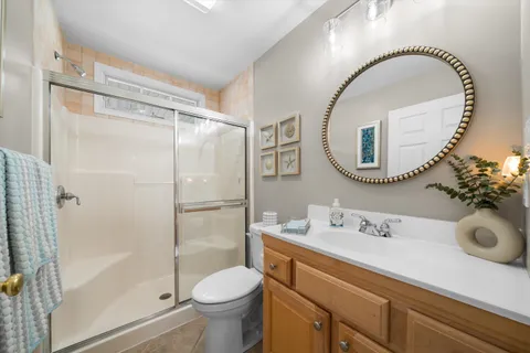 a bathroom with a sink mirror toilet and shower