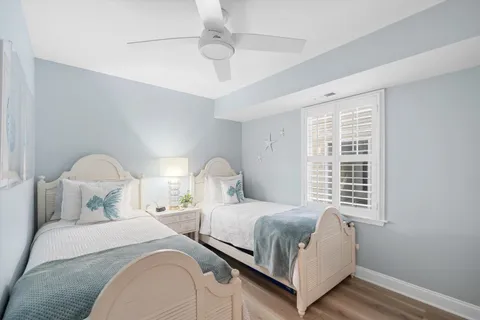a bedroom with two beds and a window