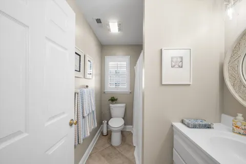 a bathroom with a toilet sink and a mirror