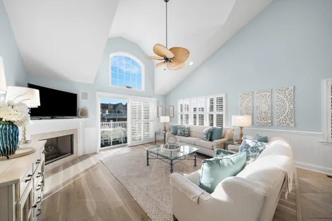 a living room with furniture a fireplace and a flat screen tv