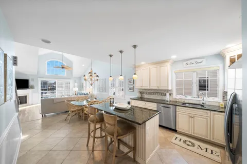 a kitchen with lots of counter top space and painting on the wall