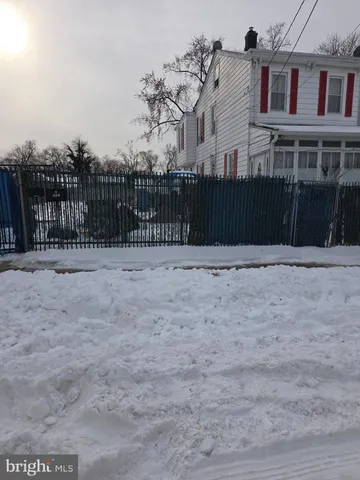 a view of a brick house next to a yard