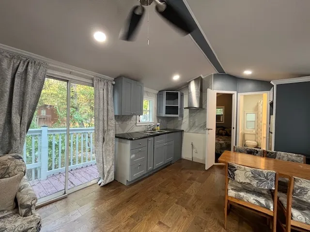 a large kitchen with a large window and stainless steel appliances