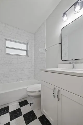 a bathroom with a sink a toilet a shower and a mirror