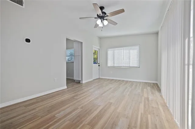 wooden floor in an empty room with a window